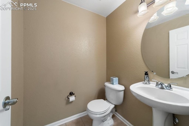 9089 Royal Melbourne Cir, Peyton, CO 80831 - bathroom with baseboards, a sink, tile patterned floors, and toilet