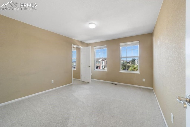 9089 Royal Melbourne Cir, Peyton, CO 80831 - unfurnished room featuring baseboards and light colored carpet
