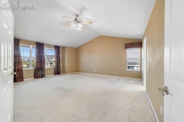 9089 Royal Melbourne Cir, Peyton, CO 80831 - unfurnished room with baseboards, a ceiling fan, vaulted ceiling, and light carpet