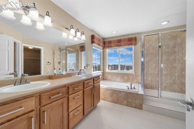 9089 Royal Melbourne Cir, Peyton, CO 80831 - bathroom featuring tile patterned flooring, a sink, a garden tub, and a shower stall