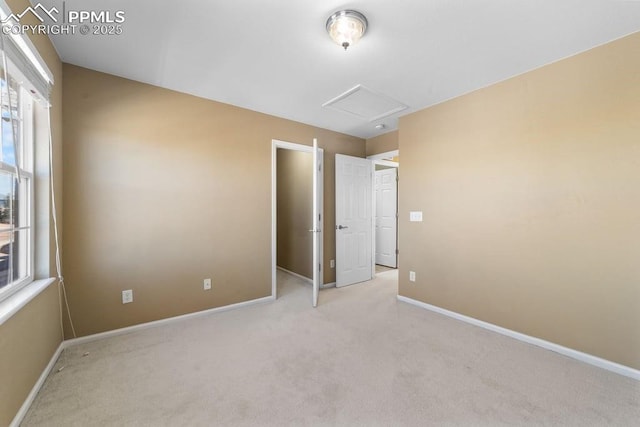 9089 Royal Melbourne Cir, Peyton, CO 80831 - unfurnished bedroom with baseboards, multiple windows, and light carpet
