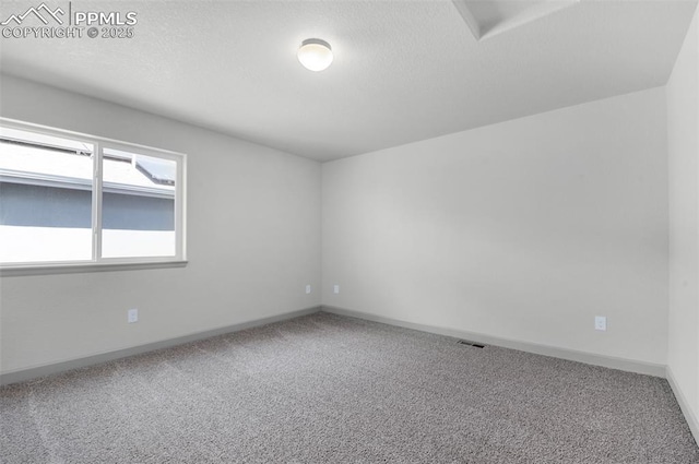 unfurnished room with baseboards, carpet, and visible vents