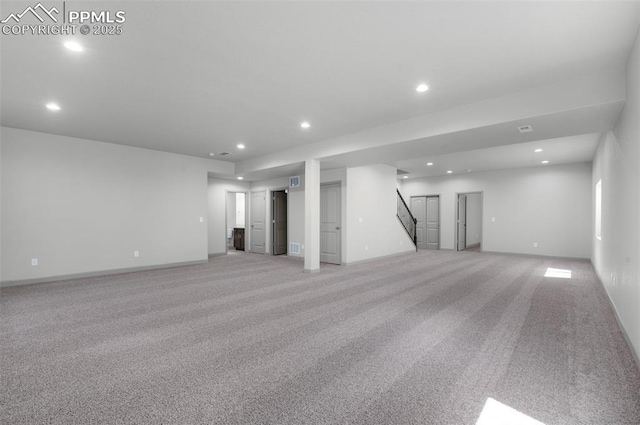 below grade area with stairway, recessed lighting, and light colored carpet