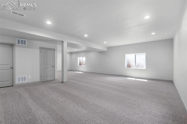 basement with visible vents, recessed lighting, and carpet flooring
