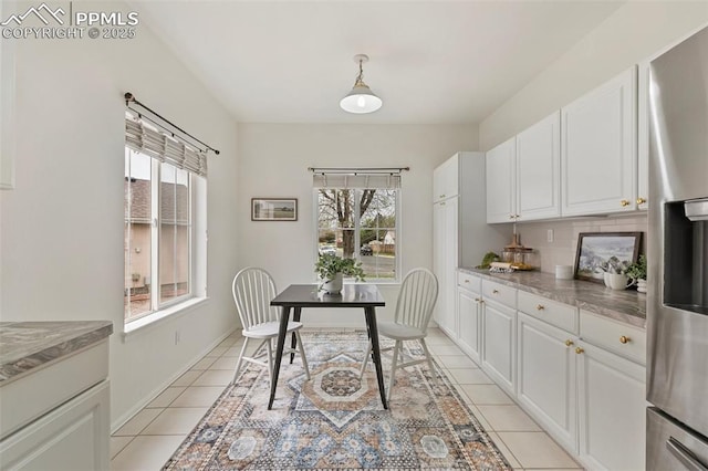 dining area with light tile patterned floors and baseboards