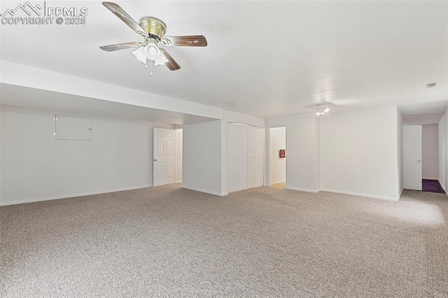 unfurnished living room with light colored carpet, ceiling fan, and baseboards