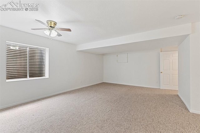 unfurnished room featuring light colored carpet, baseboards, a ceiling fan, and a smoke detector