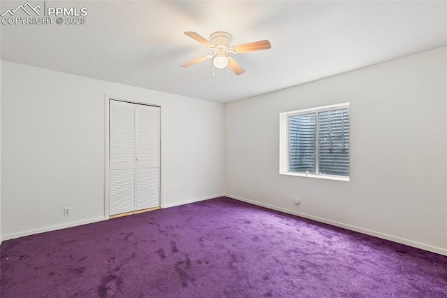 carpeted empty room featuring ceiling fan and baseboards