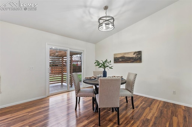 dining area featuring baseboards, wood finished floors, and lofted ceiling