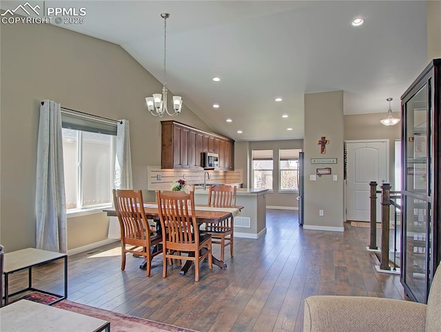 6996 Mustang Rim Dr, Colorado Springs, CO 80923 - dining room featuring a chandelier, recessed lighting, baseboards, vaulted ceiling, and dark wood-style floors