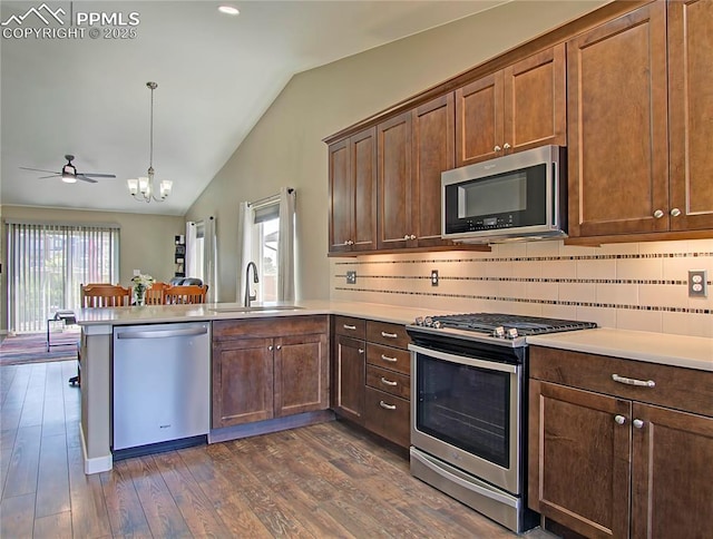6996 Mustang Rim Dr, Colorado Springs, CO 80923 - kitchen with stainless steel appliances, vaulted ceiling, a healthy amount of sunlight, and a sink
