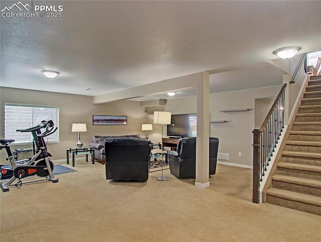 6996 Mustang Rim Dr, Colorado Springs, CO 80923 - carpeted living room with stairs, a textured ceiling, baseboards, and visible vents
