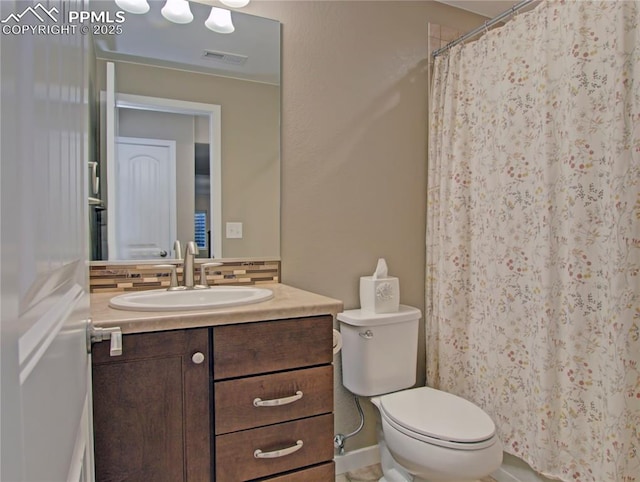6996 Mustang Rim Dr, Colorado Springs, CO 80923 - full bathroom featuring visible vents, tasteful backsplash, vanity, toilet, and a shower with shower curtain