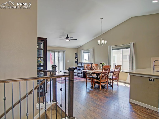 6996 Mustang Rim Dr, Colorado Springs, CO 80923 - dining area featuring baseboards, ceiling fan with notable chandelier, lofted ceiling, and dark wood-style floors