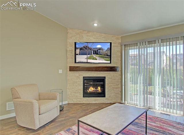 6996 Mustang Rim Dr, Colorado Springs, CO 80923 - living room with plenty of natural light, a fireplace, wood finished floors, and lofted ceiling