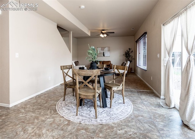 dining space featuring baseboards and ceiling fan