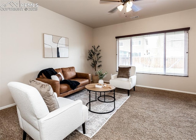 living area featuring carpet floors, ceiling fan, visible vents, and baseboards