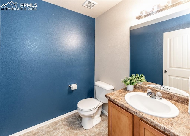 bathroom with tile patterned flooring, vanity, toilet, baseboards, and visible vents