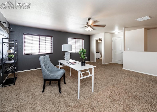 carpeted home office featuring baseboards, ceiling fan, visible vents, and a wealth of natural light