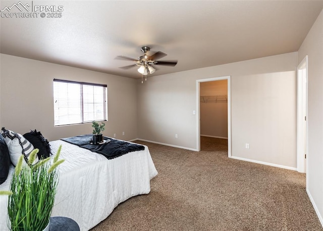 bedroom featuring baseboards, a ceiling fan, carpet flooring, and a spacious closet
