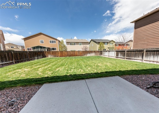 view of yard with a residential view, a fenced backyard, and a patio area