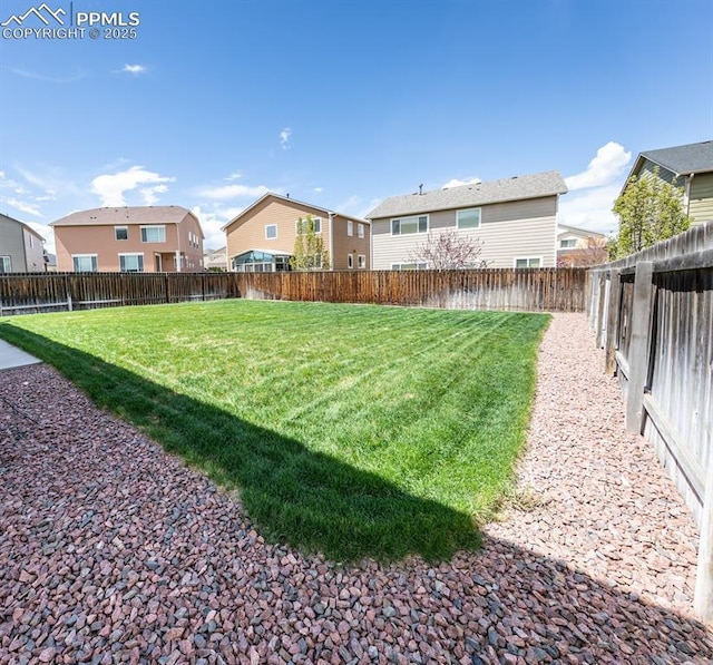 view of yard with a residential view and a fenced backyard