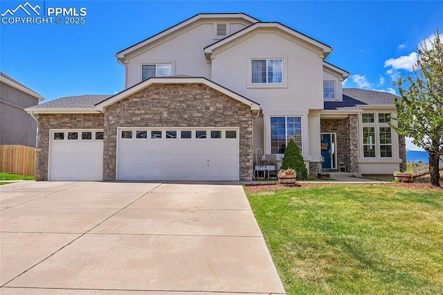 traditional-style home featuring driveway, a front yard, a garage, stone siding, and stucco siding
