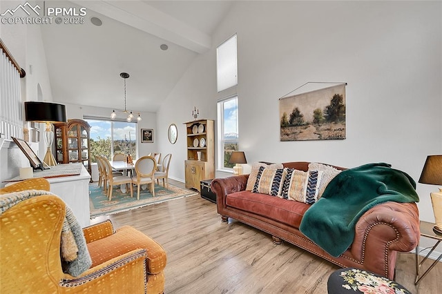 living room with beam ceiling, baseboards, wood finished floors, and high vaulted ceiling