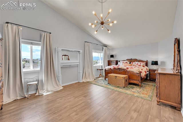bedroom with an inviting chandelier, high vaulted ceiling, and light wood-style flooring