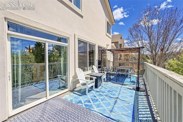 view of wooden balcony featuring a pergola and a deck