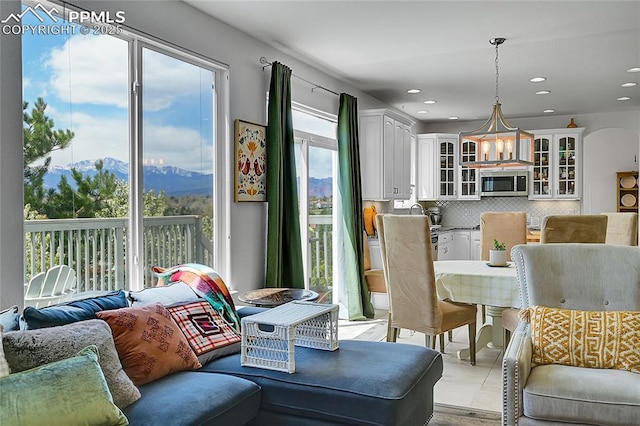 interior space with recessed lighting, a mountain view, and a chandelier
