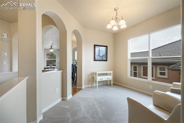 2532 Sierra Oak Dr, Colorado Springs, CO 80919 - sitting room featuring baseboards, arched walkways, carpet, and ceiling fan with notable chandelier