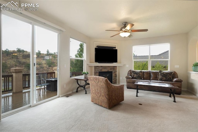2532 Sierra Oak Dr, Colorado Springs, CO 80919 - carpeted living room with a ceiling fan, baseboards, a glass covered fireplace, and a wealth of natural light