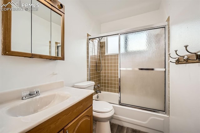 full bathroom featuring vanity, bath / shower combo with glass door, toilet, and wood finished floors