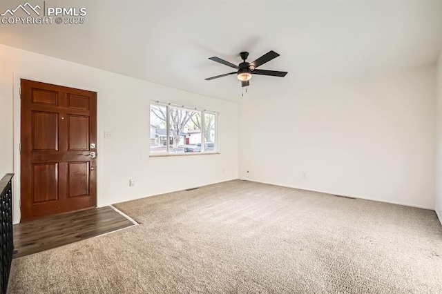 interior space with visible vents, carpet flooring, and ceiling fan