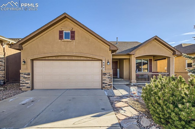 6041 Leon Young Dr, Colorado Springs, CO 80924 - view of front of house featuring stucco siding, stone siding, covered porch, and concrete driveway