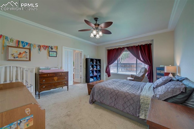bedroom featuring carpet flooring, a ceiling fan, and crown molding