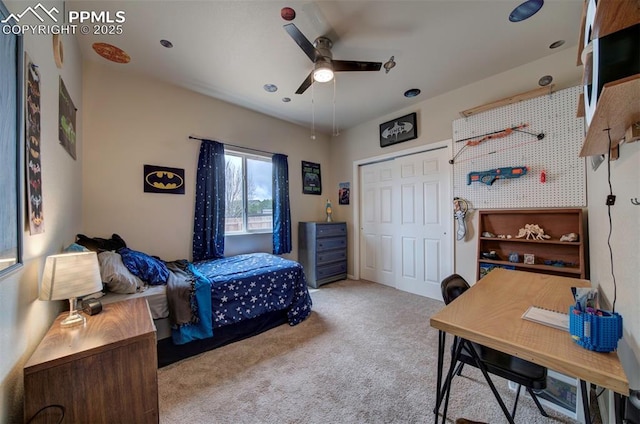carpeted bedroom with a ceiling fan and a closet