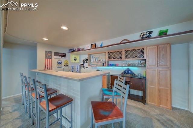 bar with indoor bar, recessed lighting, baseboards, and light carpet