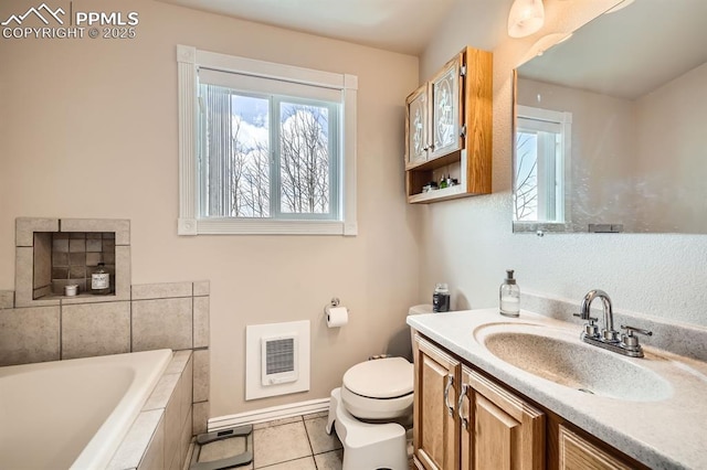 119 Bristlecone Ln, Fairplay, CO 80440 - bathroom with a relaxing tiled tub, heating unit, a wealth of natural light, and vanity