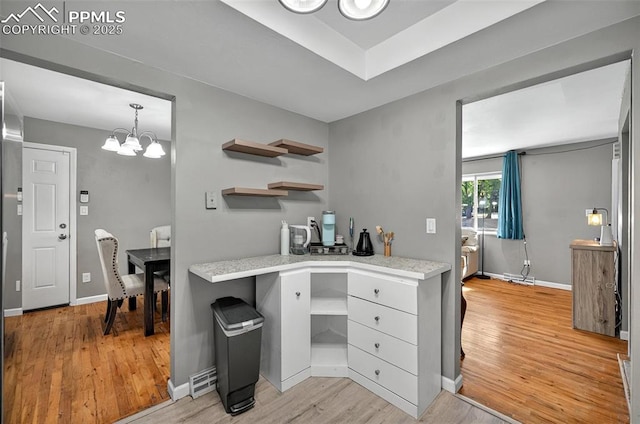 806 N Chelton Rd, Colorado Springs, CO 80909 - kitchen with open shelves, light wood-type flooring, and a chandelier