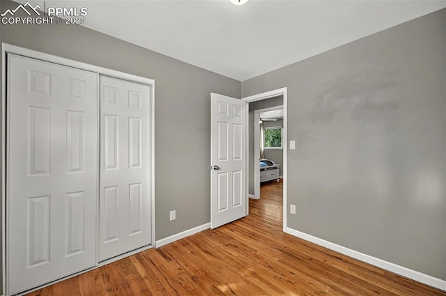 806 N Chelton Rd, Colorado Springs, CO 80909 - unfurnished bedroom featuring baseboards, wood finished floors, and a closet