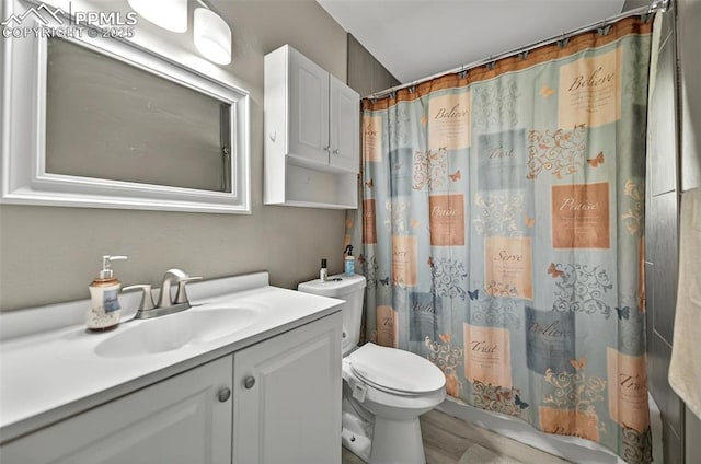 806 N Chelton Rd, Colorado Springs, CO 80909 - full bath featuring toilet, vanity, a shower with shower curtain, and wood finished floors
