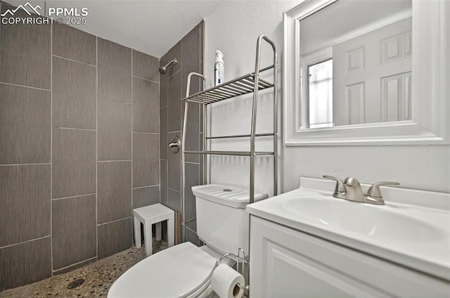 806 N Chelton Rd, Colorado Springs, CO 80909 - bathroom with toilet, tiled shower, and vanity
