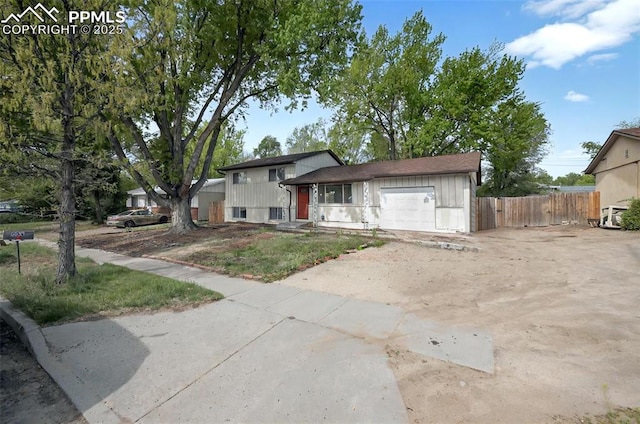 806 N Chelton Rd, Colorado Springs, CO 80909 - tri-level home featuring driveway, a garage, and fence