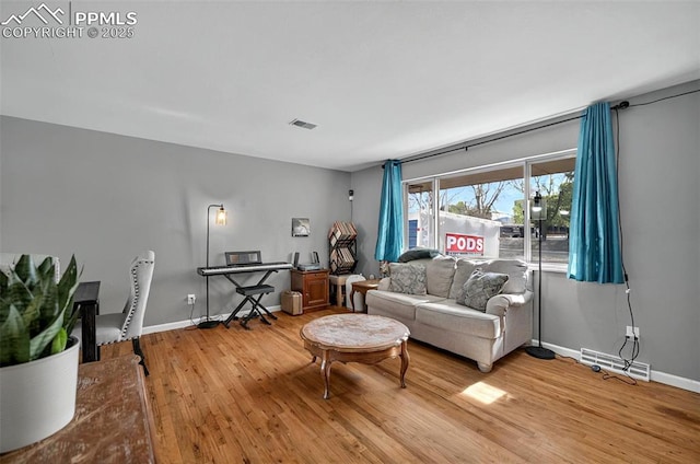 806 N Chelton Rd, Colorado Springs, CO 80909 - living room featuring light wood-style floors and baseboards