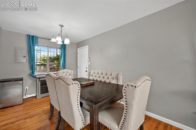 806 N Chelton Rd, Colorado Springs, CO 80909 - dining area featuring a chandelier, baseboards, and light wood-type flooring