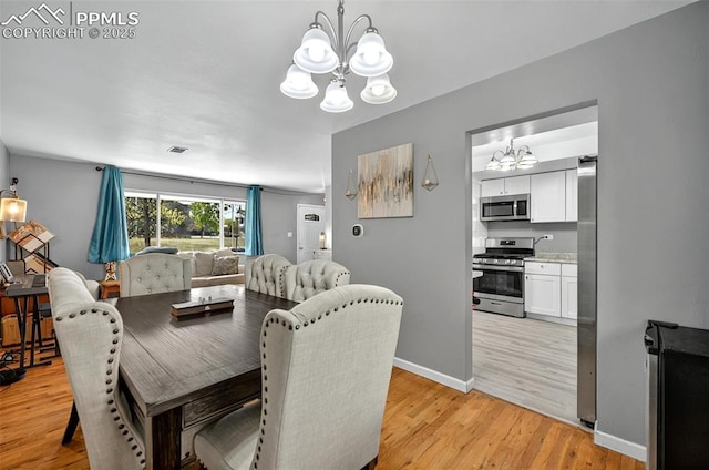 806 N Chelton Rd, Colorado Springs, CO 80909 - dining area featuring a chandelier, light wood-style floors, and baseboards