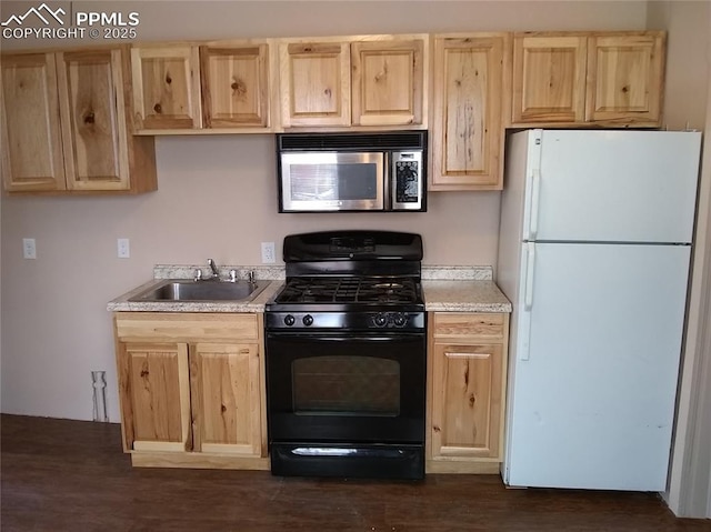322 Platte Ct, Colorado Springs, CO 80903 - kitchen with stainless steel microwave, black range with gas cooktop, freestanding refrigerator, and light brown cabinets