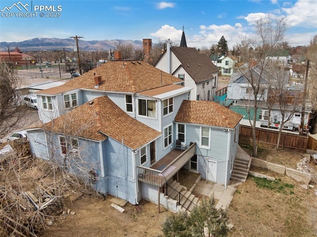 322 Platte Ct, Colorado Springs, CO 80903 - rear view of house with stairs, fence, a mountain view, roof with shingles, and a residential view